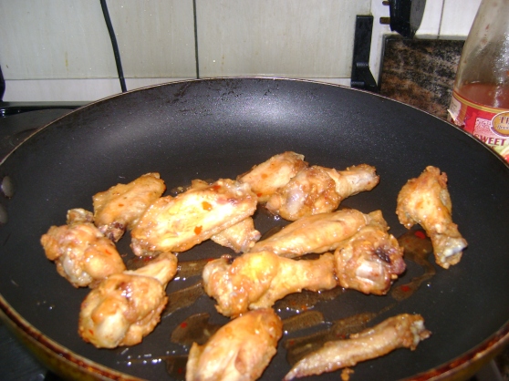 Chicken wings and sweet chili being heated through